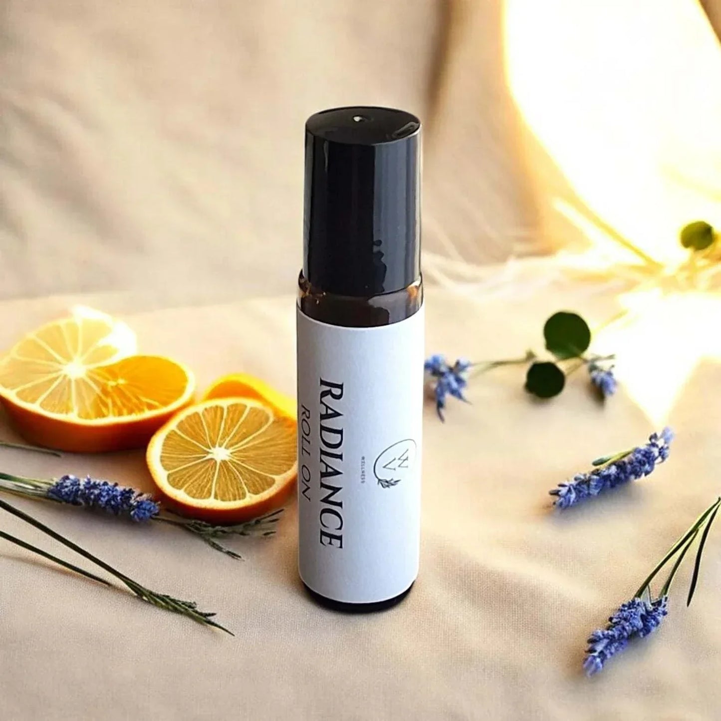 Radiance botanical roll-on with warm floral spice aroma, bright citrus, and soft resin notes