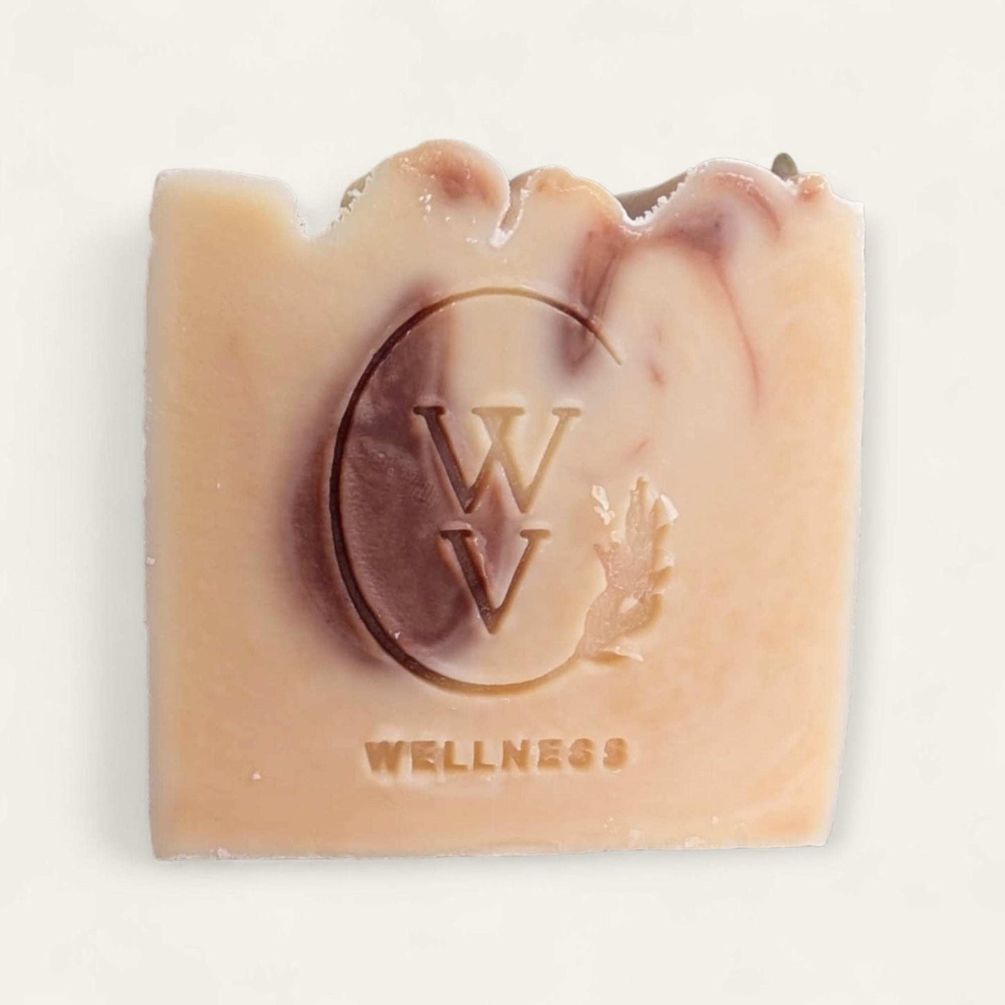 A handcrafted bar of cocoa cream soap with a rich brown color, smooth texture, and natural chocolate tones, surrounded by cocoa beans and butter.