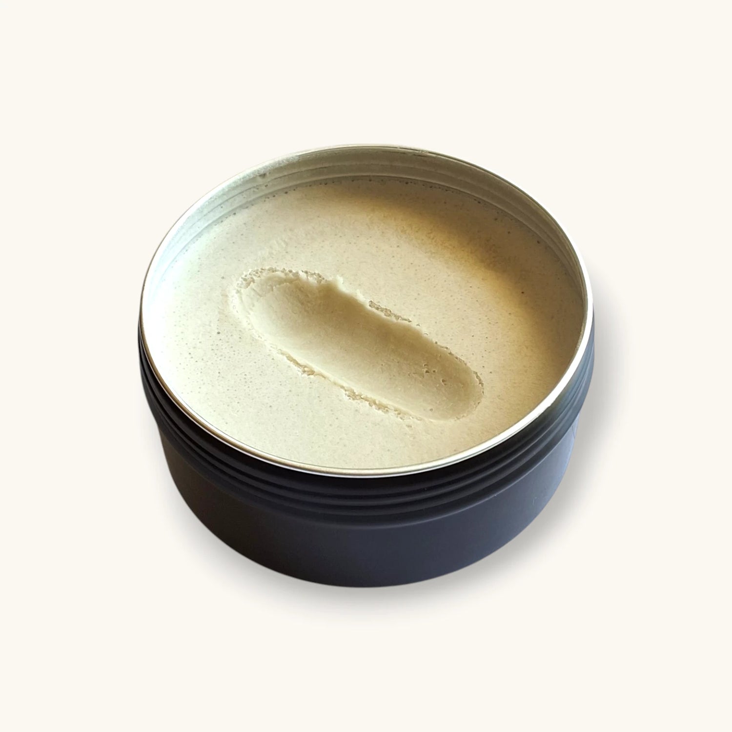 Aluminum-free natural deodorant paste with smooth, creamy texture shown by finger swipe, handcrafted in Canada