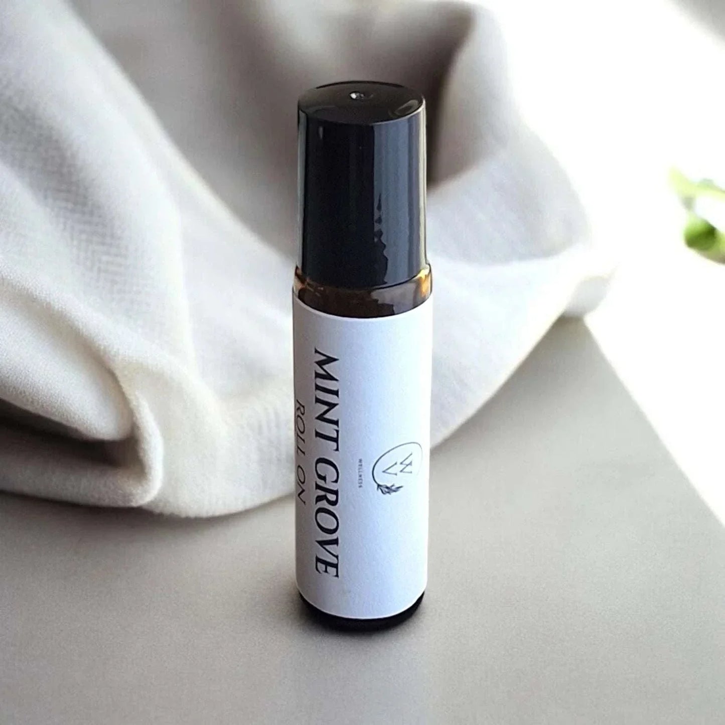 Mint Grove essential oil roll-on with cooling eucalyptus, peppermint, lemon, rosemary, and tea tree