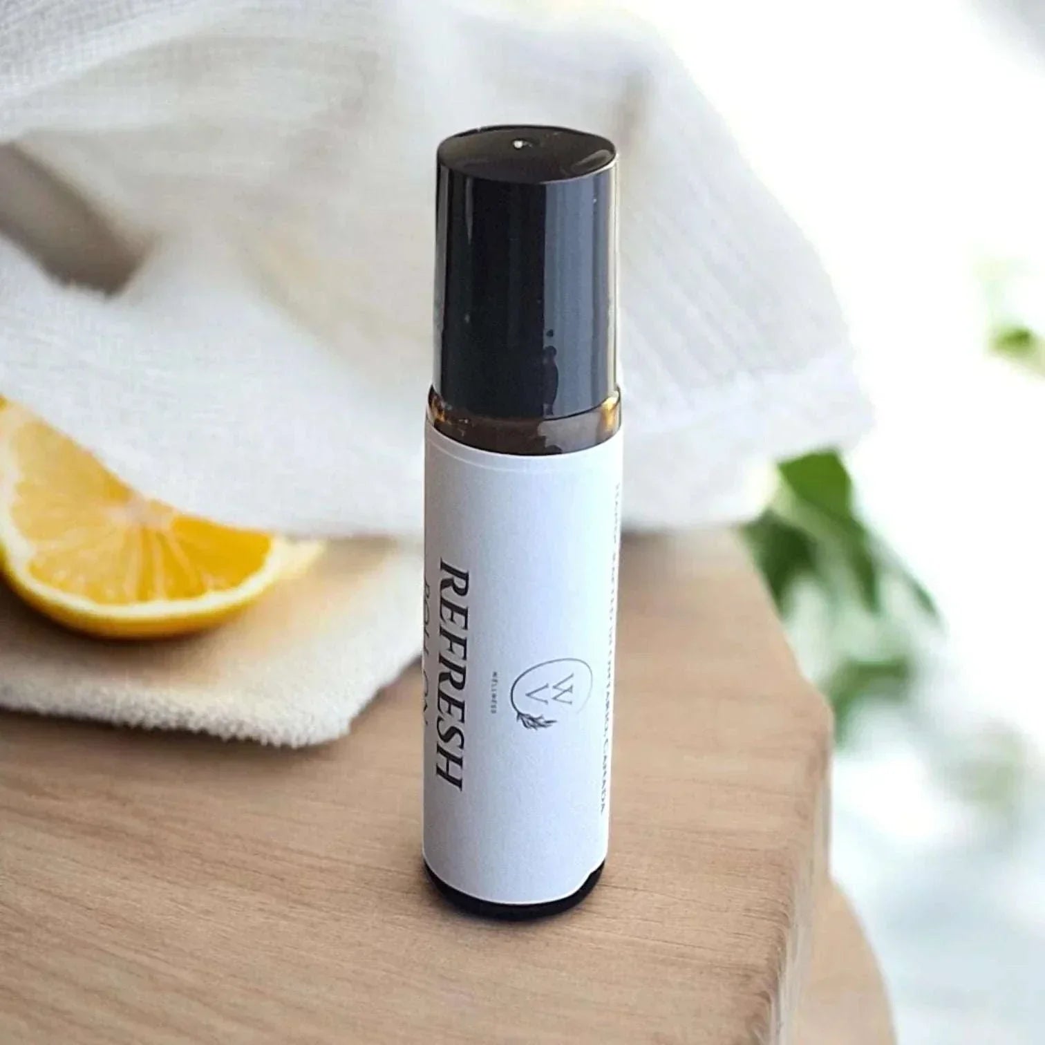 Refresh essential oil roll-on with sweet orange, lime, rosemary, lavender, and frankincense in jojoba oil