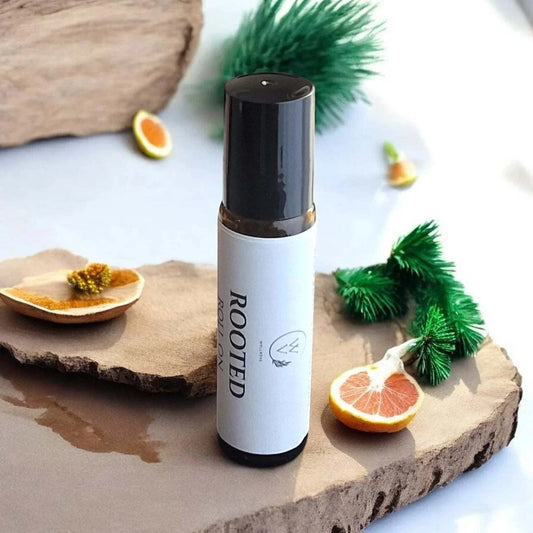 Rooted Roll-On essential oil blend with grapefruit, black spruce, lime, cedarwood, frankincense, vetiver, and patchouli