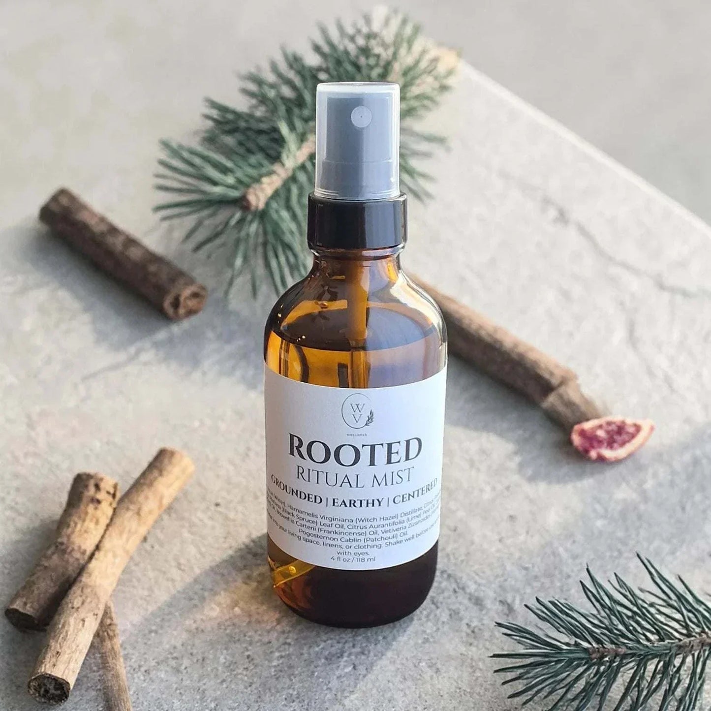 Rooted Ritual Mist earthy woody essential oil room spray with grapefruit, black spruce, cedarwood, vetiver, and patchouli.