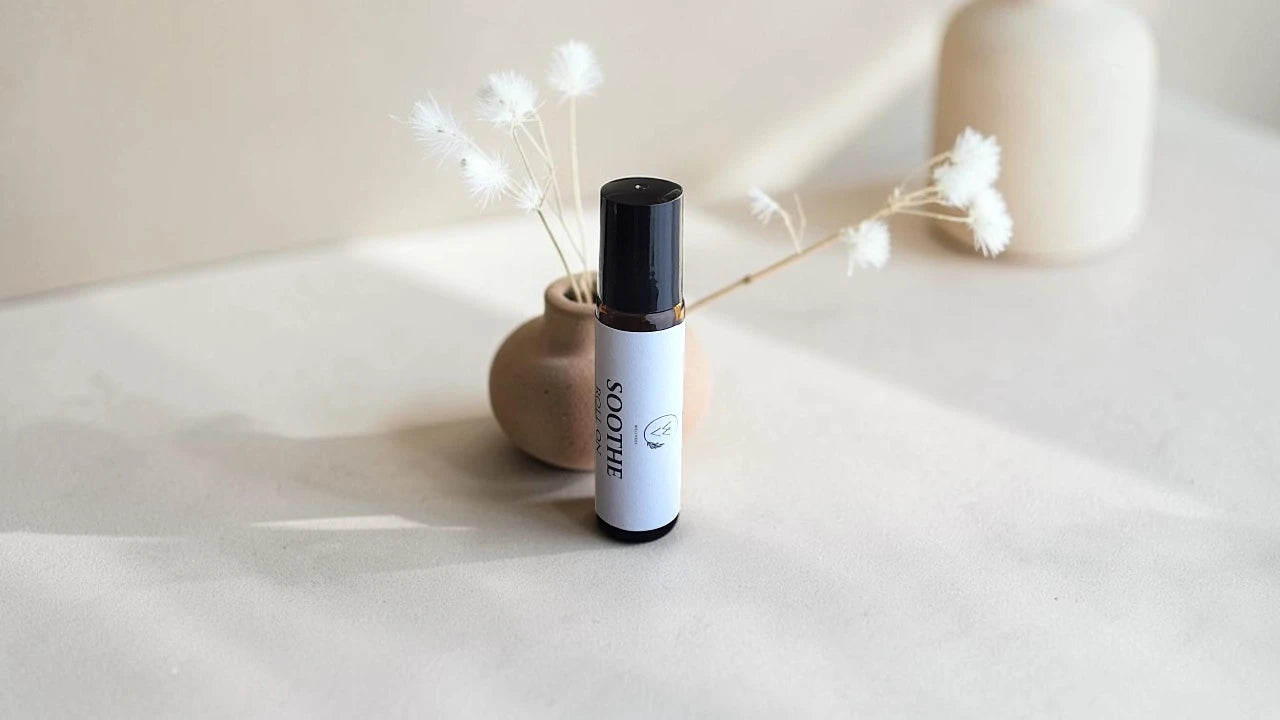 Essential oil roll-on collection with botanical background and natural scent ritual styling