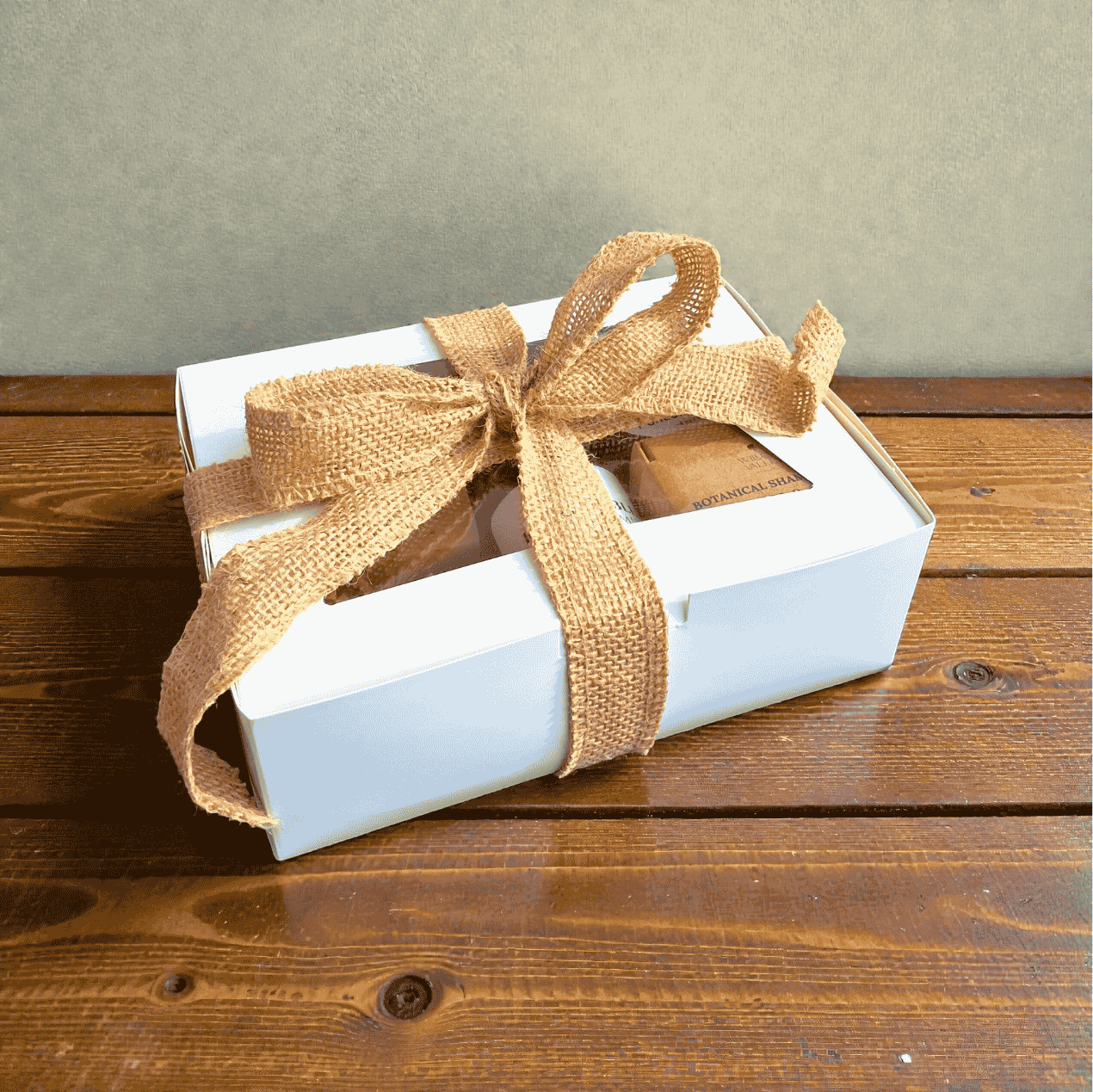 Willow Wellness Gift Set in a white box tied with a burlap ribbon, filled with natural skincare essentials.