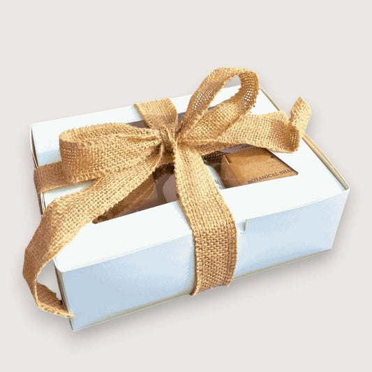 Willow Wellness Gift Set in a white box tied with a burlap ribbon, filled with natural skincare essentials.