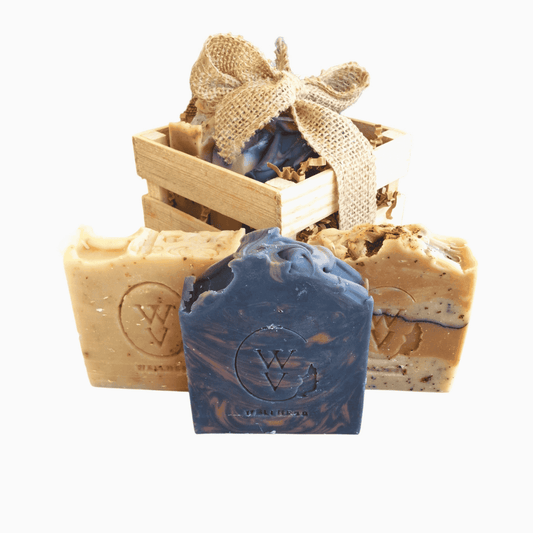 Natural self-care gift set with three handcrafted soaps in a rustic wooden box.