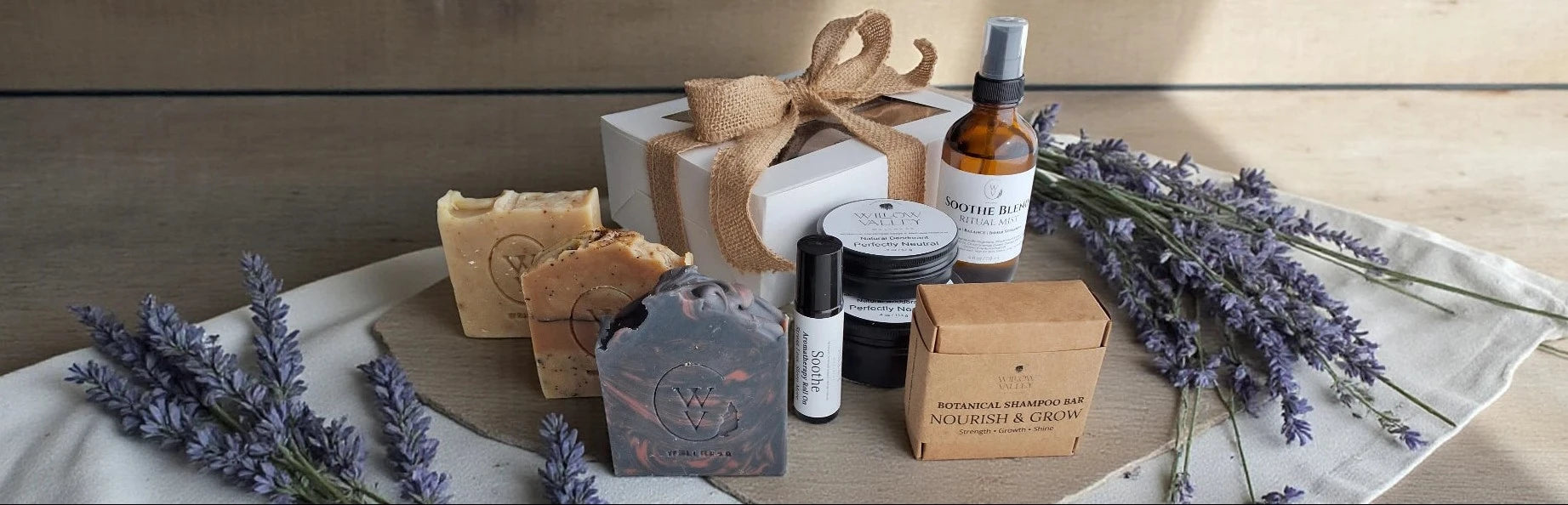 Willow Valley Wellness natural personal care products including deodorant, shampoo bars and soaps with lavender on a wooden surface