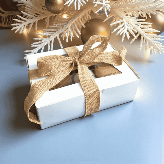 Willow Wellness Gift Set in a white box tied with a burlap ribbon, filled with natural skincare essentials.